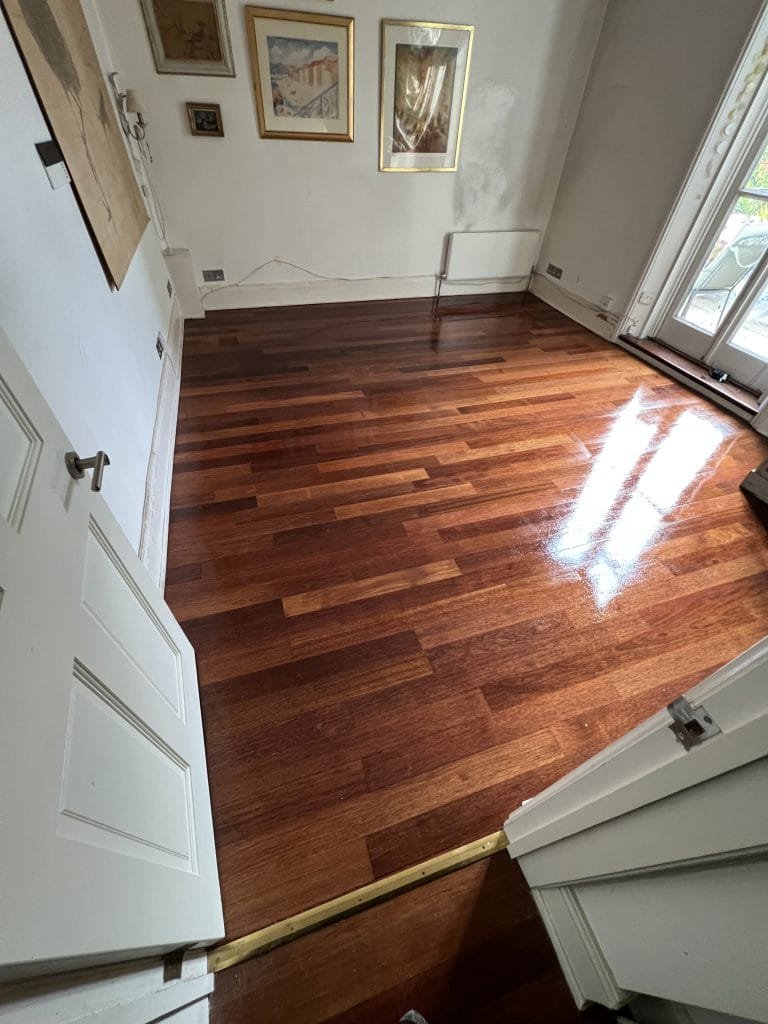 Solid teak floor restored following carpet removal.