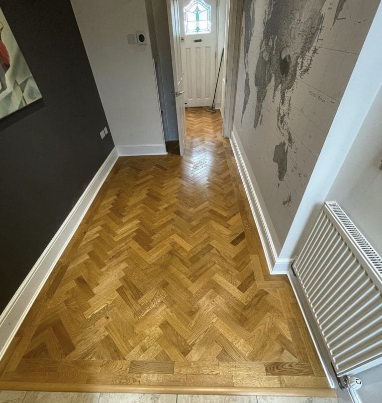 Smoked oak herringbone parquet installation.